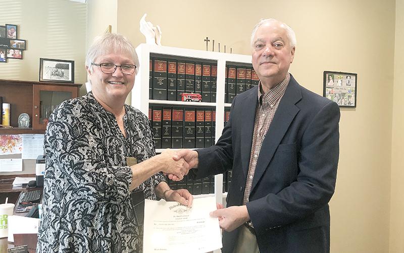 School board member Joey Duncan (right) is sworn in Monday morning by Judge Pam Wooley.