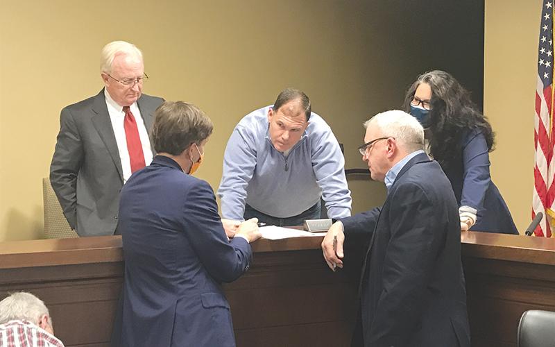 Outgoing Habersham County Chairman Stacy Hall (center) conferences with (clockwise from top left) County Manager Phil Sutton, Vice Chair Natalie Crawford, Commissioner Tim Stamey and Andrew Tritt, Managing Director of Stifel Investment Services at the Dec. 21 meeting.