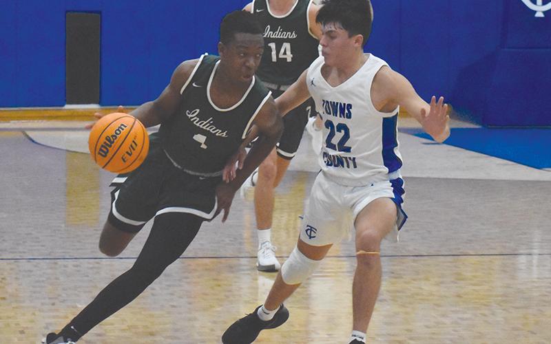 Tallulah Anfernee Hanna (left) looks to drive past Towns County's Kabe Ellis on Dec. 3.