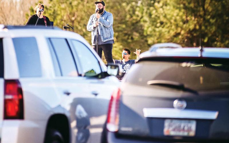 Eric and Misty Wilcox sing at The Torch’s drive-up prayer service March 22 at one of the first socially-distanced worship services during the COVID-19 crisis.