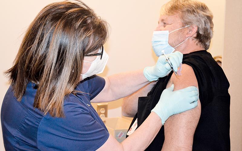 Dee Dillin, the imaging services director at Habersham Medical Center, is the first person in Habersham County to get the vaccine Wednesday, administered by nurse Kim Albertson.