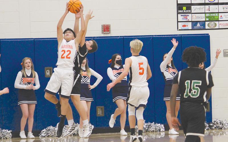 Brody Bantaum skies for a rebound in the seventh grade championship game. The Raiders knocked off Franklin County 43-36 to win the title.