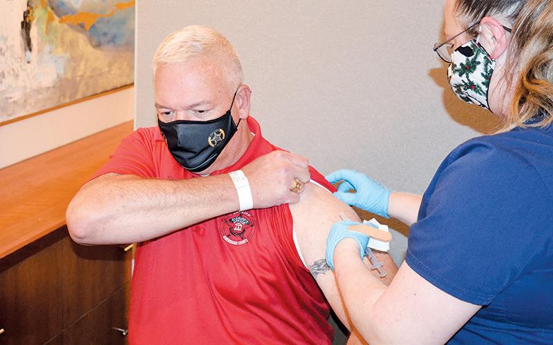 Habersham County Sheriff Joey Terrell gets his COVID-19 vaccine Monday afternoon at Habersham Medical Center from nurse Heather Nichols.