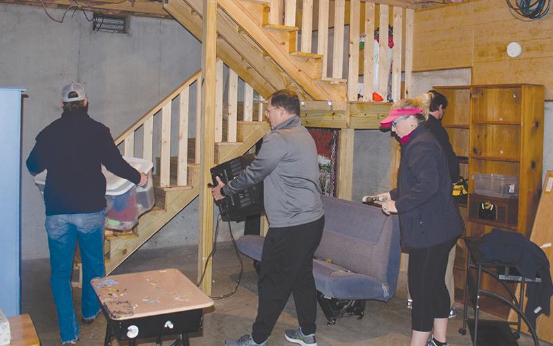 Local nonprofit The Everyday Good is currently working with a local family to finish a basement to expand sleeping, learning and work space. Shown, from left, are Ken Johnson, and Stacy and Ivy Hall.