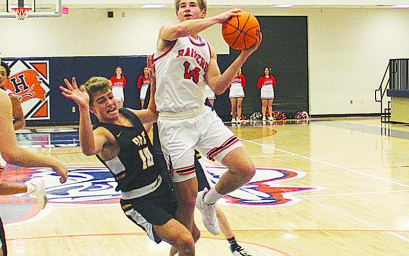 Senior guard Grant Tipton finishes through contact during a game against Prince Avenue earlier this season.
