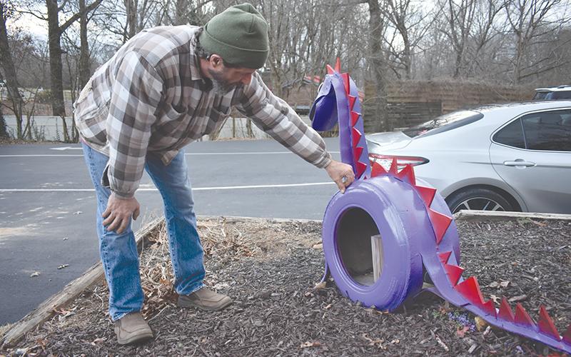 Todd Lincks says hello to his creation, Cooper, who sits in front of Kandy Kane Learning Center in Clarkesville.