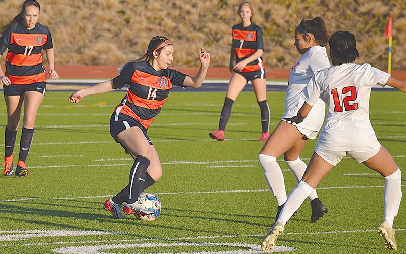 Habersham Central’s Abigail Deleon (14) looks to avoid two Gainesville defenders during Tuesday’s game.