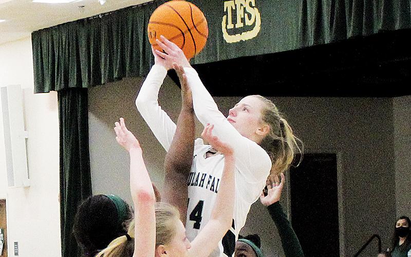 Macy Murdock finishes a layup over three Lady Wolves defenders.  Murdock will be one of the returning players looked to for leadership next season with the Lady Indians losing three senior starters.