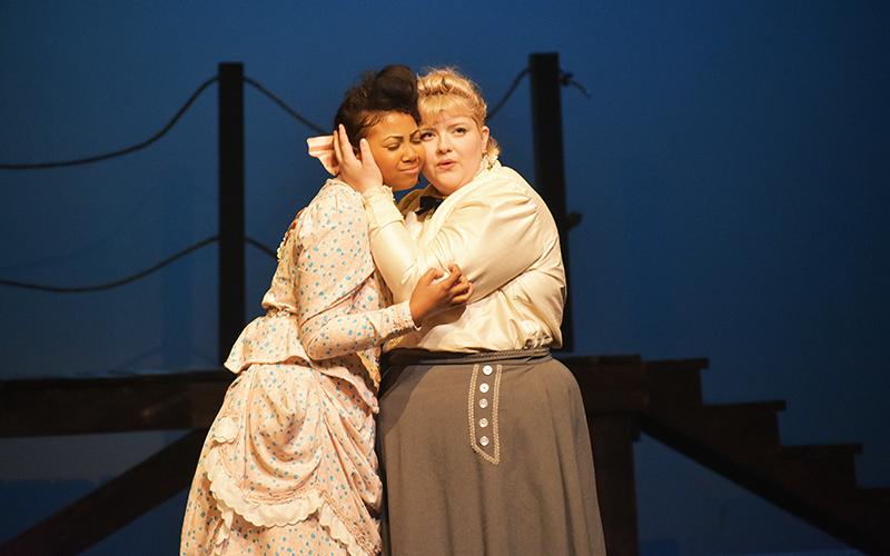 Nettie Fowler (right), played by Ellawyn Ketch, hugs her cousin Julie Jordan, played by Chandler Allen in Piedmont’s production of “Carousel.” CHAMIAN CRUZ/Staff