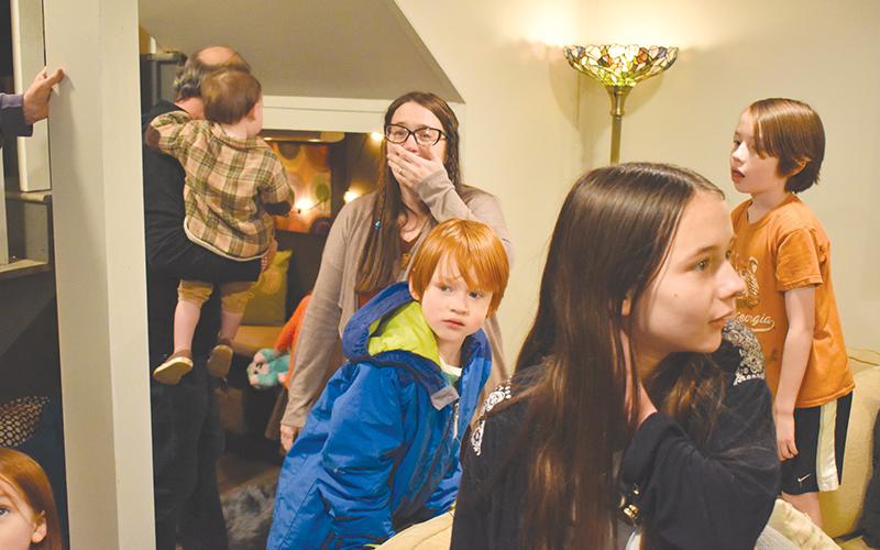 Mackenzie Chester is in shock seeing her new basement for the first time after it was renovated by more than 60 volunteers from the community. Also getting a look around are her sons Remy (red hair) and Kells, along with daughter Rosanna.