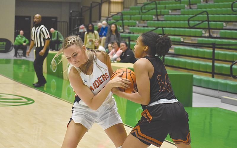 Habersham Central’s Hailey Wade (left) battles Lanier’s Kiara Johnson for possession during Friday’s regional semifinal.