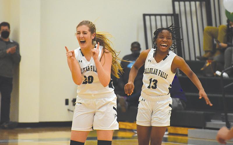 Tallulah Falls’ Katy Corbett celebrates with teammate Veronaye Charlton during the second half of Friday’s game. Corbett hit 10 3-pointers to set a school record.