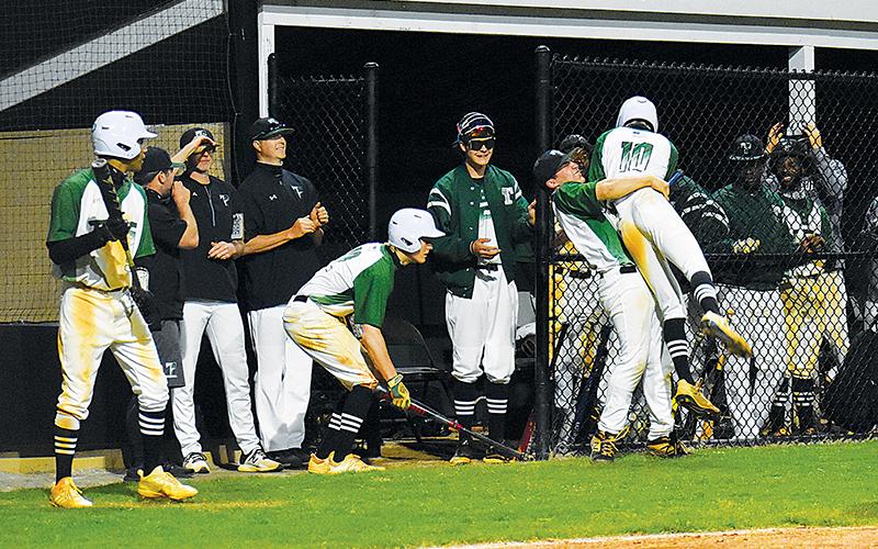 Tallulah Falls’ Tyler Popham gets a hug from Tate Shaw after scoring a run against George Walton on Tuesday.