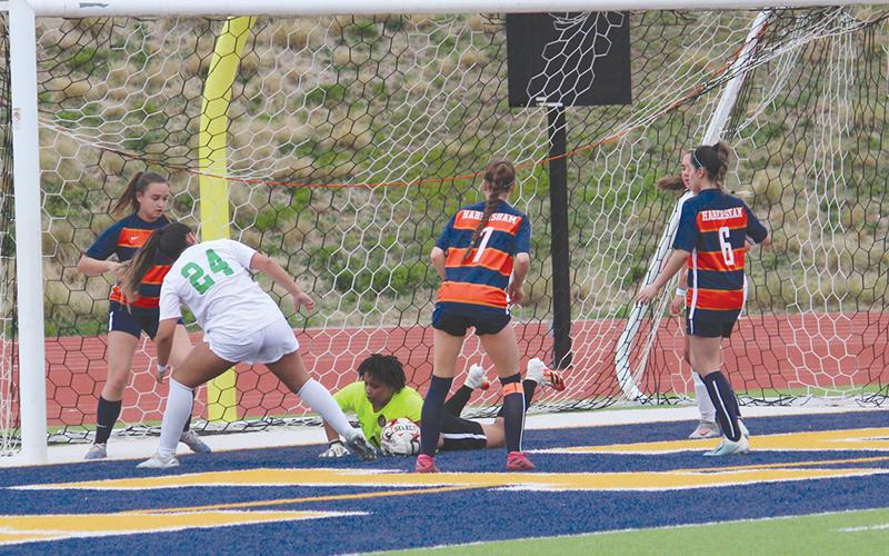 Nykerrah Brown dives to smother a shot from a Buford forward during Tuesday night’s contest. Brown recorded several saves to keep the Lady Raiders within striking distance in the first half.