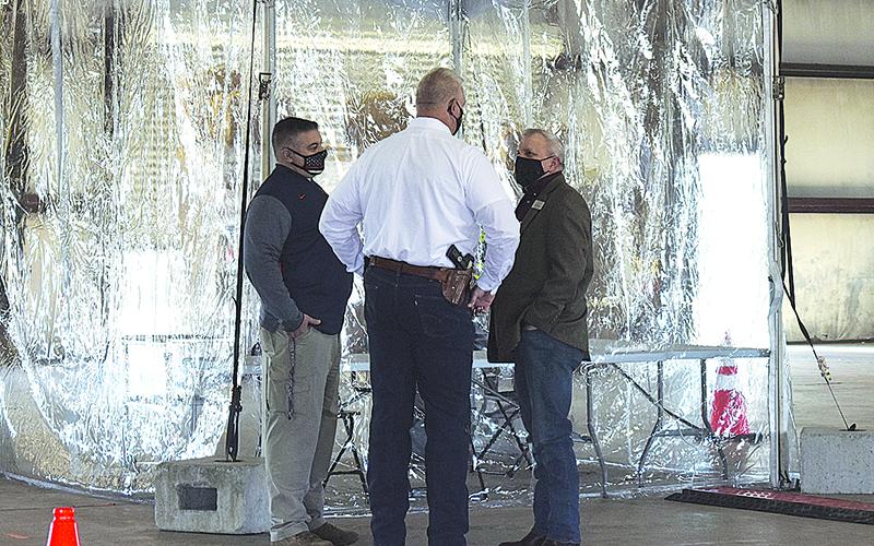 Habersham County Sheriff’s Lt. Murray Kogod, Sheriff Joey Terrell and Habersham County Commissioner Tim Stamey talk over the logistics of the mass vaccination site in Clarkesville when public officials toured it on Feb. 19.