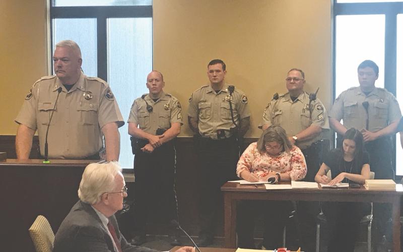 Sheriff Joey Terrell (left) appeared at Monday’s county commission meeting to plead for help with staffing his department, as there are 18 open positions on the force. He was joined by several officers, including (from left) Sgt. Ethan Neal, Deputy Tyler Moon, and Cpl. Brian Collins.  Deputy Dakota Nguyen (out of frame right) and Lt. Travis Jarrell (obscured behind the sheriff) also attended to show their support.