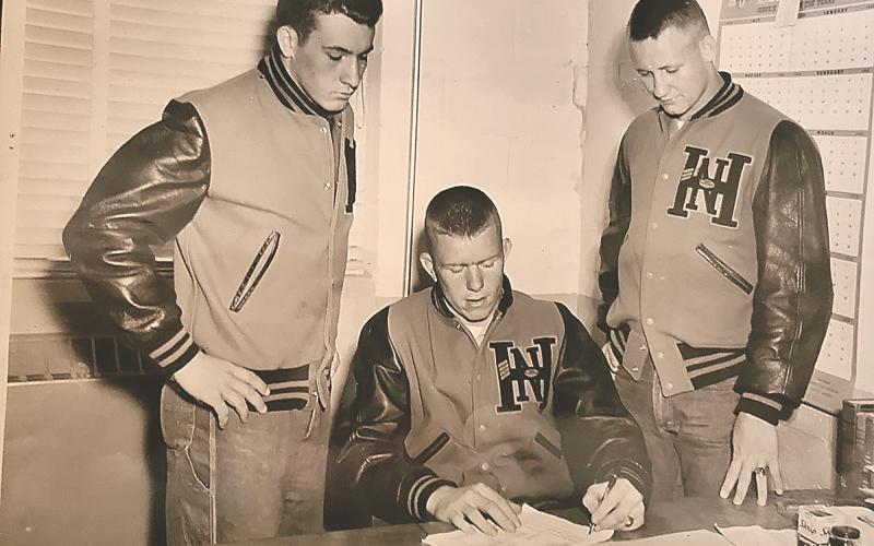 Red Black (center) signs with UGA to play baseball following his senior season at North Habersham High School as teammates Ernest Todd (left) and Howard Burke (right) look on. Black was a three-sport star for the Bobcats and was awarded All-State Honorable Mention honors following the 1954 football season. Photo submitted by Chuck Black.