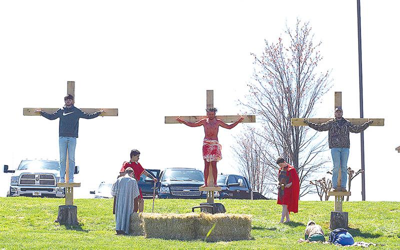 Nick Daunch, one of the participants who played Jesus last Friday, is shown with his brothers, Luke and Noah Daunch, playing the two thieves. Marcus Herrera and Jack Butterworth played the guards.