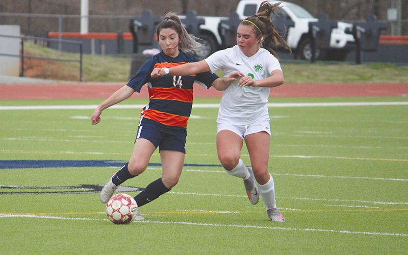 Abigail Deleon (14) battles Buford’s Emma Chaffee in a recent match. The Lady Raiders secured a playoff berth last Thursday with a 2-0 road victory over Winder-Barrow.