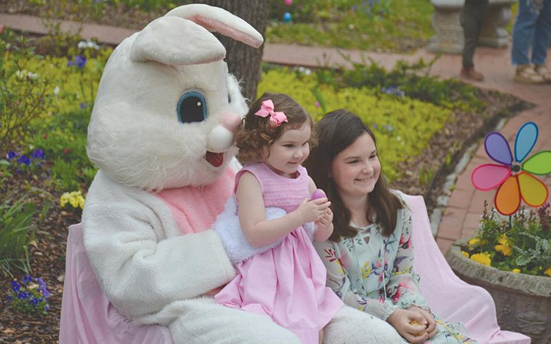 The Easter Bunny visits with Hannah Hilliard, 3, and her sister Natalie, 9 at the Mauldin House gardens in Clarkesville.