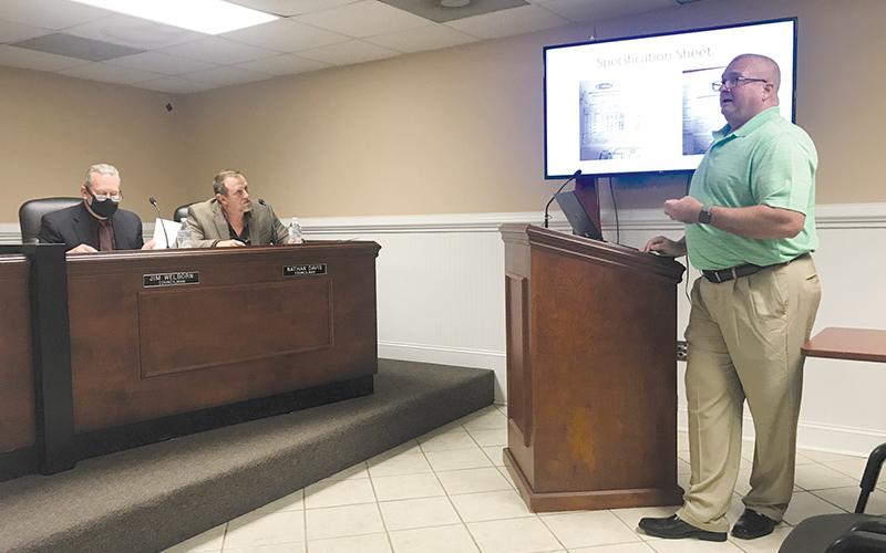 Longtime firefighter Johnny Irvin explains to the Demorest City Council, including Councilmen Jim Welborn and Nathan Davis, his recommendations for a fire truck purchase.