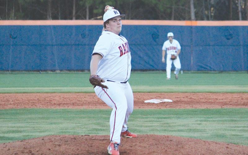Habersham Central’s Hunter Tatum  delivers in Game 1 against Winder-Barrow on Monday.