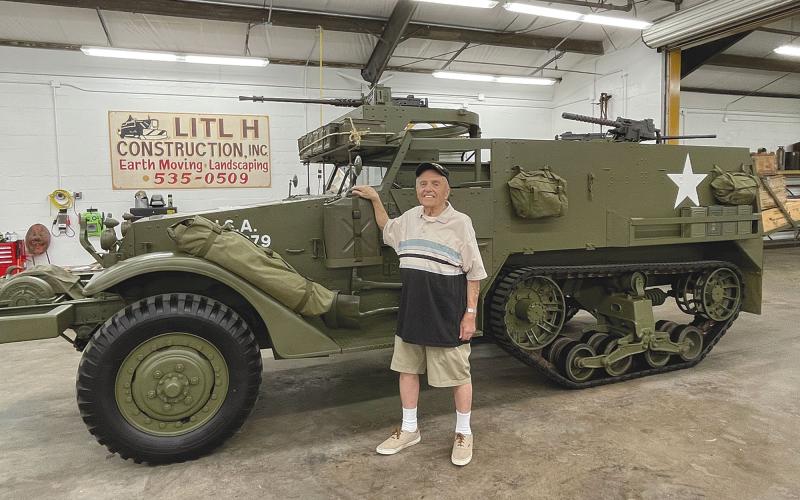 Andy Negra took a look at a halftrack military vehicle at Joe Hatfield’s workshop in  Clarkesville on Thursday. Negra drove a  similar vehicle in World War II. BRIAN WELLMEIER/Staff
