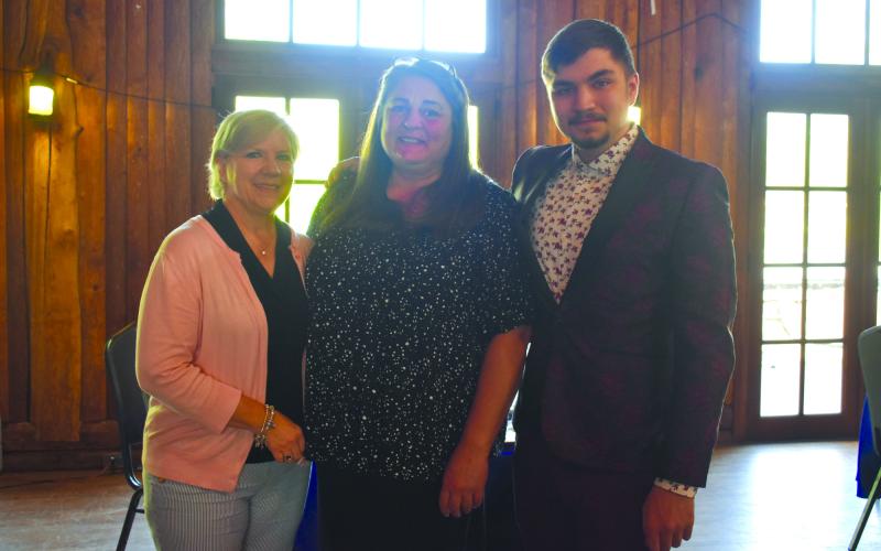 HCHS teachers Angie Nunnally and Gulnur Pendaz smile alongside senior Ege "AJ" Keskin