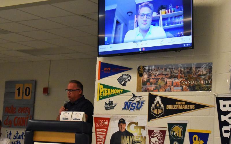 Former Raiders head coach Gene Cathcart (left) speaks about former player Marty Patterson (above on Zoom) during the Ring of Honor induction ceremony. ISAIAH SMITH/Staff