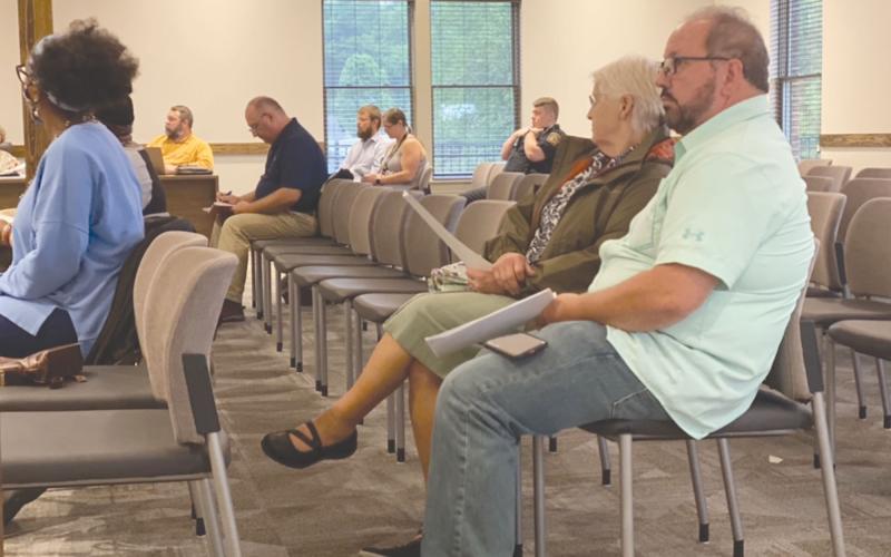 Lifelong Habersham County resident Ernie Garrett, far right, said on Tuesday he has done all he can to stop the erosion on his property from Camp Creek, but he can’t afford to keep taking matters into his own hands. CHAMIAN CRUZ/Staff
