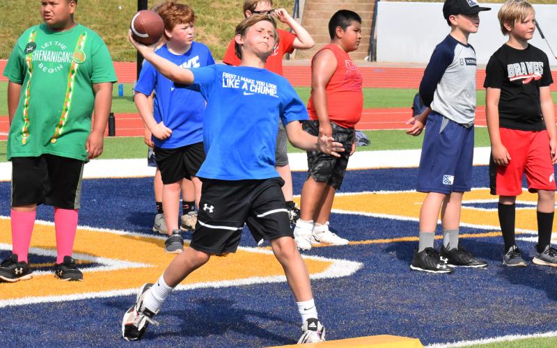 Grayson Holcomb winds up to fire a pass toward a member of the Raiders coaching staff. ISAIAH SMITH/Staff