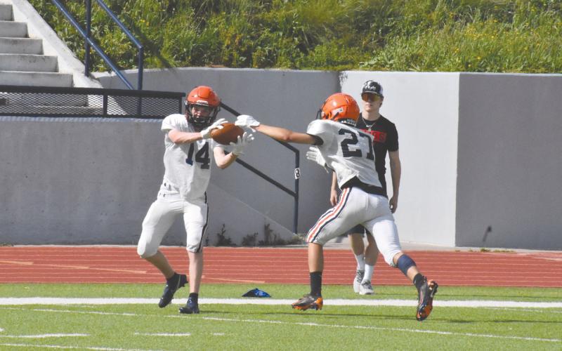 Canon Wilbanks (14) tries to make a catch while Grayson Means (27) extends to try and knock the ball away. ISAIAH SMITH/Staff