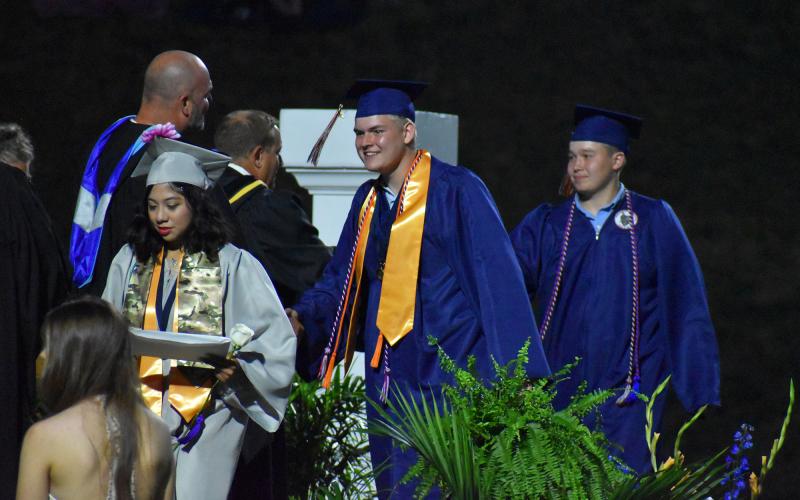 Joseph Terrell shakes hands with Superintendent Matthew Cooper as he receives his diploma. MATTHEW OSBORNE/Staff