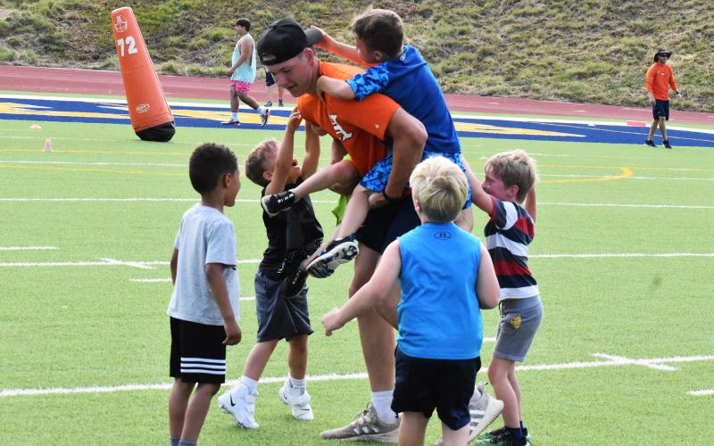 Habersham Central rising senior Jonathan Adams is overwhelmed by young tacklers. ISAIAH SMITH/Staff