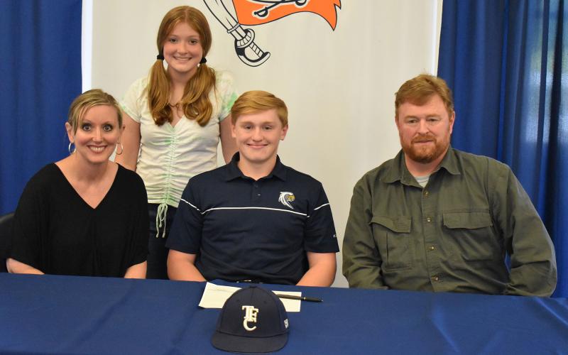 Austin Jones (center) committed to Toccoa Falls College. He was joined by his mother Grace Jones (left), father Darrell Jones (right) and sister Ashley (back).
