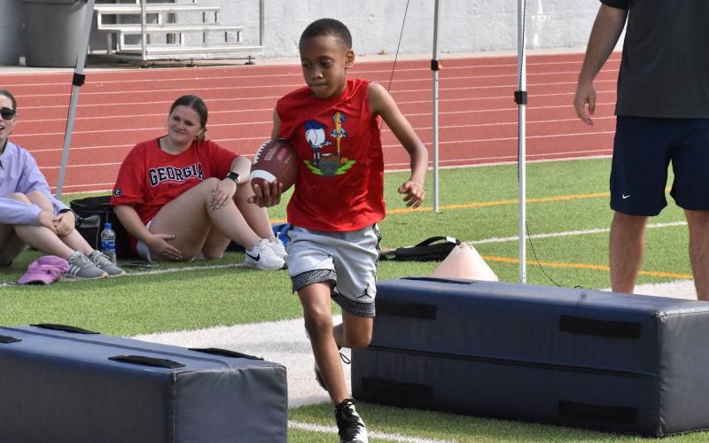 Mantario Stowers carries the ball during a drill at football camp. ISAIAH SMITH/Staff
