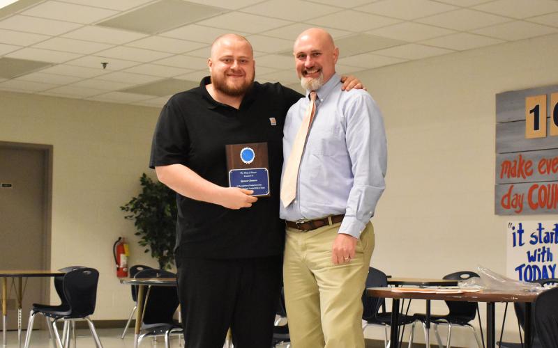 Spencer Romero (left) became an official member of the Ring of Honor Thursday night after being introduced by his former offensive line coach Chris Warbington (right). ISAIAH SMITH/Staff