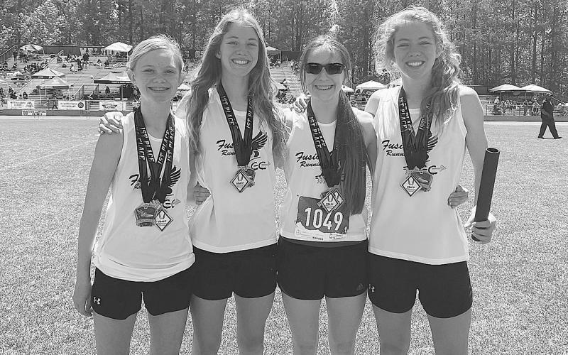 The Team Fusion 4x800 relay team of (from left) Megan Hightower, Audrey Hotard, Ansley Moore and Abigail Hotard grabbed first at the Georgia Middle School State Track Championships in Lilburn. T. GABRIEL HOTARD/Submitted