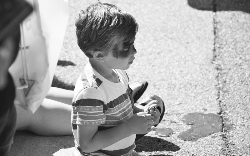 Turner Ledford of Mt. Airy takes in the parade and looks for his next shot at candy in the streets. MATTHEW OSBORNE/Staff