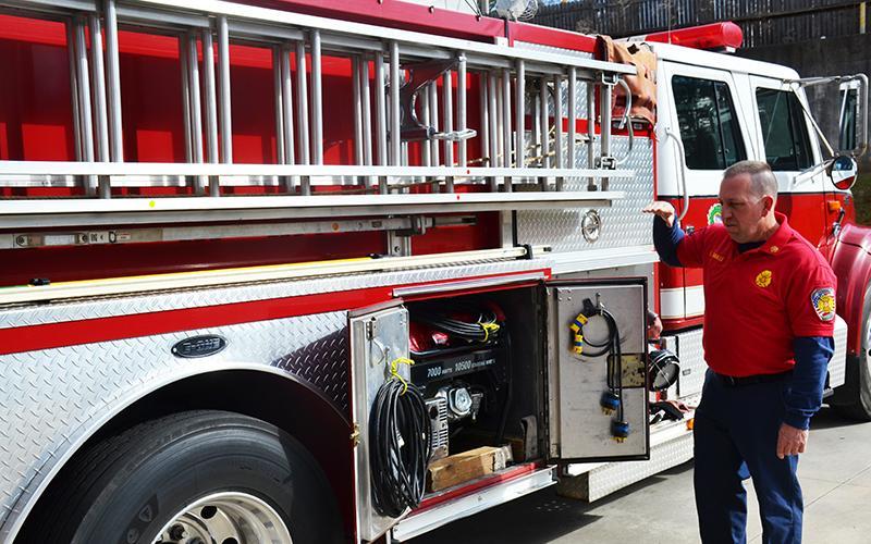 Demorest Fire Chief Ken Ranalli explains the features of his truck earlier this year.
