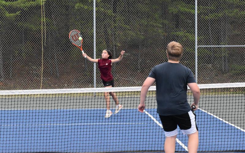Josie Plaisted extends to send a ball back across the net during a match at tennis camp. ISAIAH SMITH/Staff
