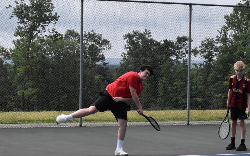 Rylee Smith practices his serve at TFS’ tennis camp Wednesday. ISAIAH SMITH/Staff
