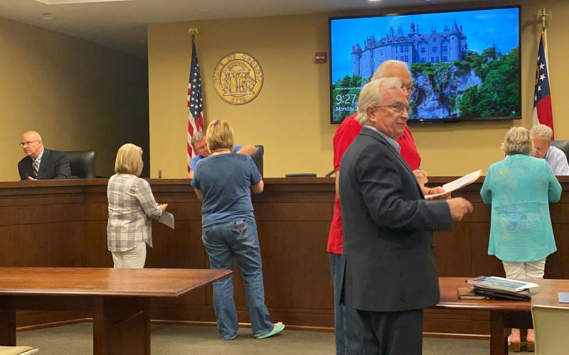 Habersham County Manager Phil Sutton and Habersham County Commissioner Jimmy Tench talk following Monday morning’s airport commission meeting. CHAMIAN CRUZ/Staff
