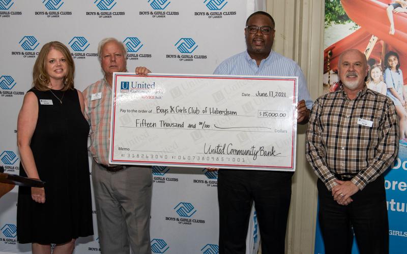 Kim Reed, Wade Rhodes, Steven Mickens and Tim Ash present a $15,000 donation from United Community Bank to the Habersham County Boys &amp; Girls Club at Thursday’s open house. CARSON SPRINKLE/Special