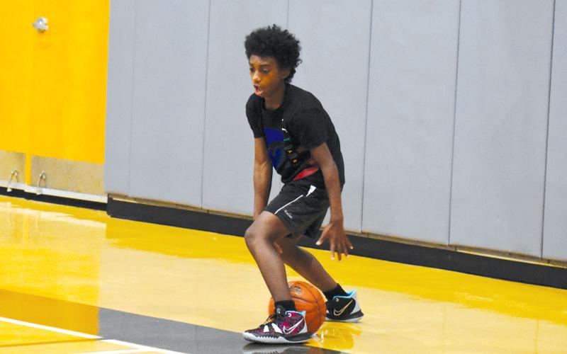 Quincy Smith works on dribble moves during camp. ISAIAH SMITH/Staff