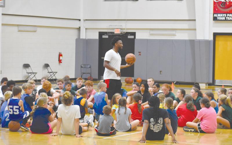 Coach Shamir Dooley speaks to campers following the first day of his MAJ Hoops Championship Skills Camp. ISAIAH SMITH/Staff