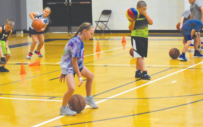Mckenzie McCoy works on going behind her back during a group drill at MAJ Hoops Championship Skills Basketball Camp Tuesday morning. ISAIAH SMITH/Staff
