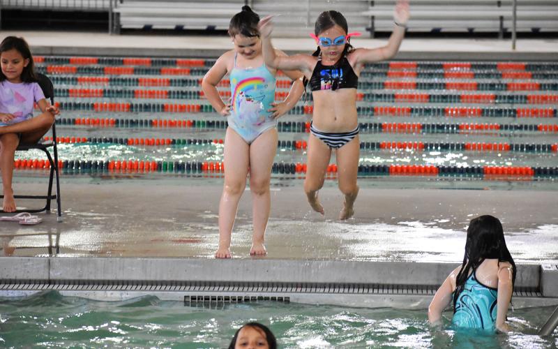 Kyla Sellers takes a leap into the water during Tuesday’s swim day. ISAIAH SMITH/Staff