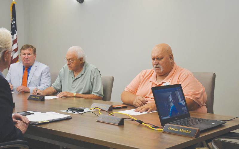 County Commissioners Bruce Harkness, Jimmy Tench and Bruce Palmer hold called meeting before executive session. BRIAN WELLMEIER/Staff