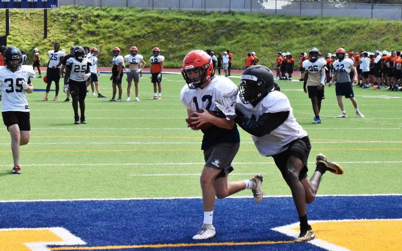 Gage Church hauls in a long touchdown pass during the Raiders’ padded team camp. ISAIAH SMITH/Staff